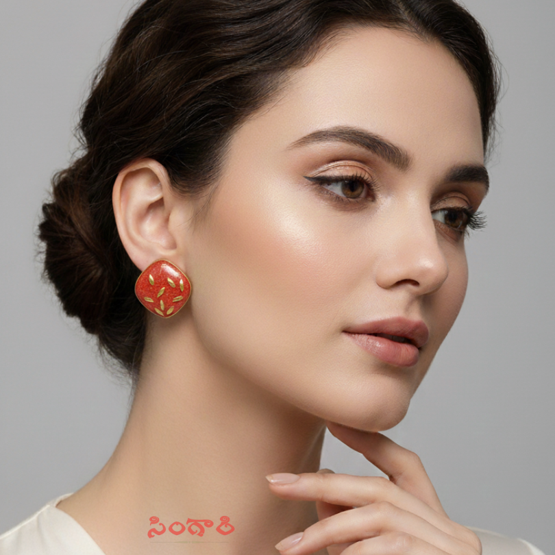 Woman wearing a red earring with a gray background