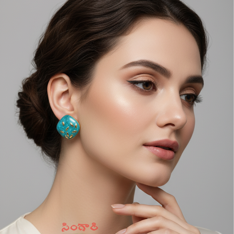 Woman wearing turquoise earrings with a gray background