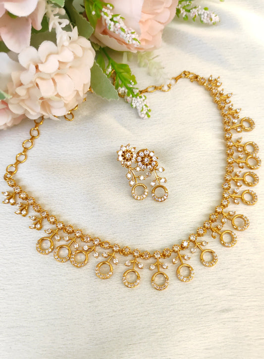 American diamond necklace and matching earrings set adorned with small white colour stones