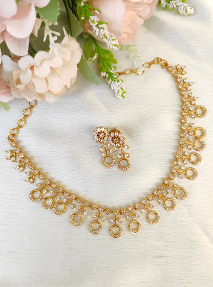 American diamond necklace and matching earrings set adorned with small white colour stones