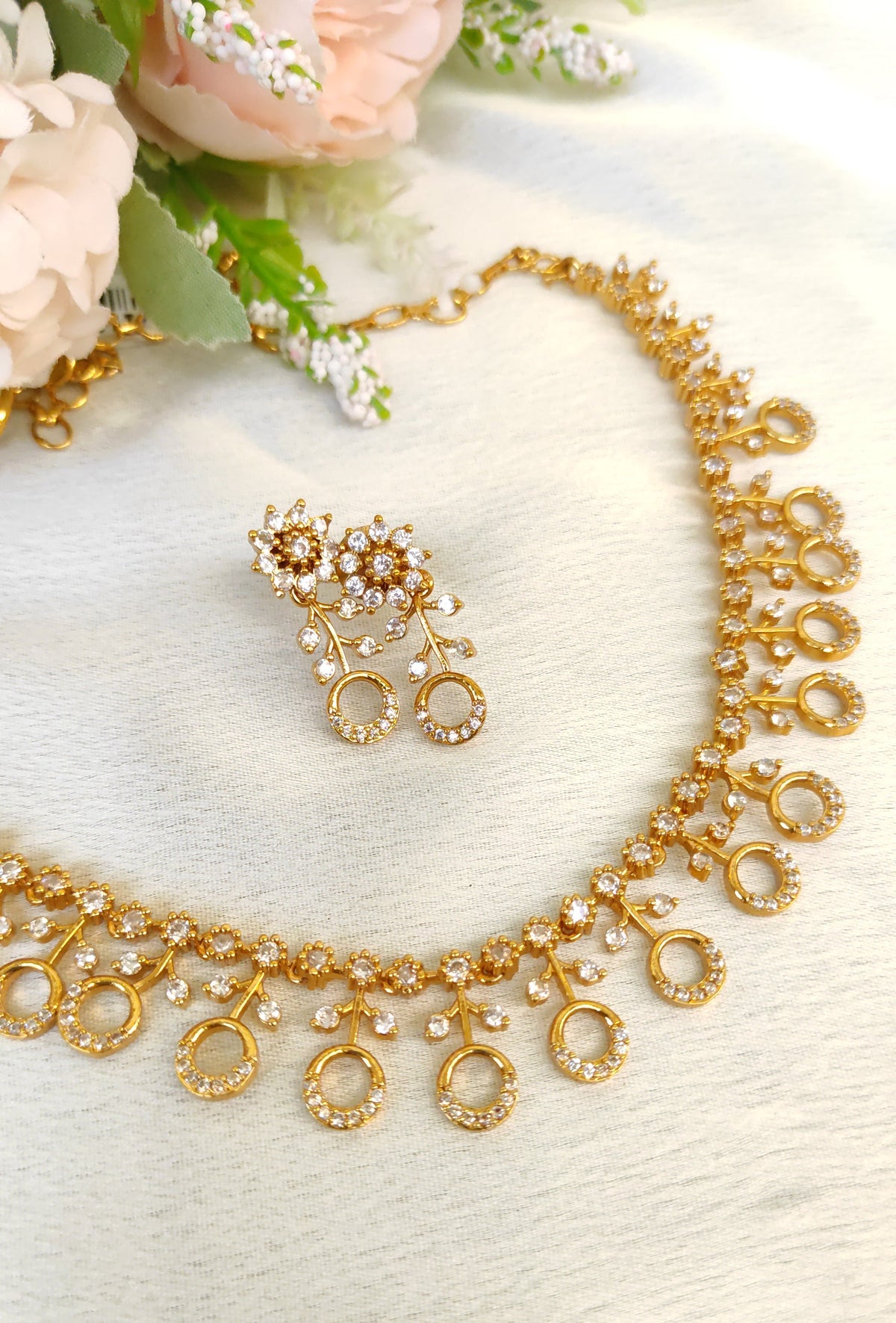 American diamond necklace and matching earrings set adorned with small white colour stones