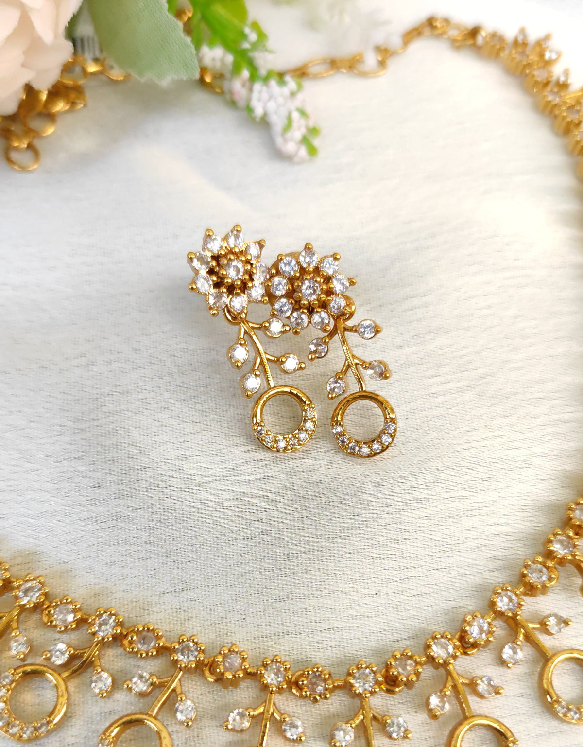 American diamond necklace and matching earrings set adorned with small white colour stones