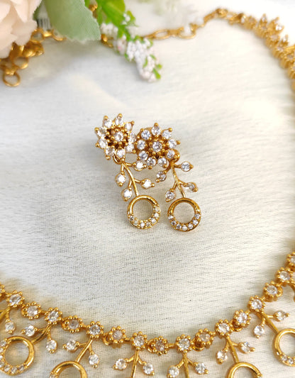 American diamond necklace and matching earrings set adorned with small white colour stones